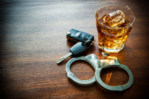DWI Lawyer - Whiskey with car keys and handcuffs concept for drinking and driving